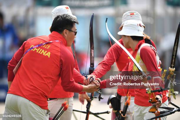 The Chinese team of Hui Cao, Yuejun Zhai and Xinyan Zhang prepare during Recurve Women's Team Archery Final Rounds on day nine of the Asian Games on...