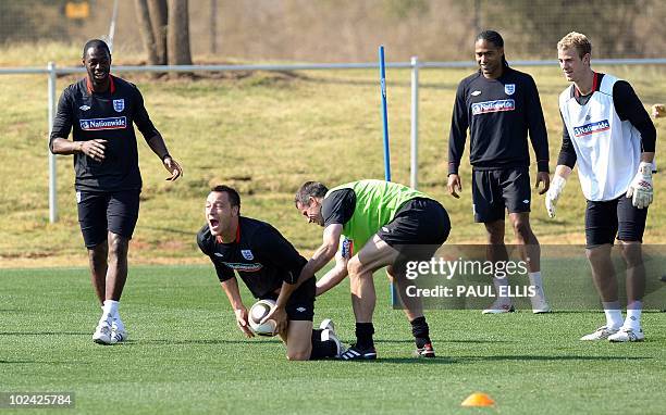 England's defender John Terry takes the ball during a training session at the Royal Bafokeng Sports Campus near Rustenburg on 26 June ahead of their...