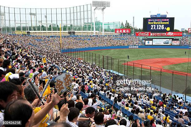 Fans cheer as the new Guinness World Record for the largest toast is displayed on the large screen after the attempt during the eighth inning of the...