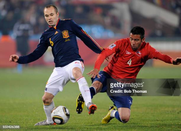 Andres Iniesta of Spain battles for the ball with Mauricio Isla of Chile during the 2010 FIFA World Cup South Africa Group H match between Chile and...