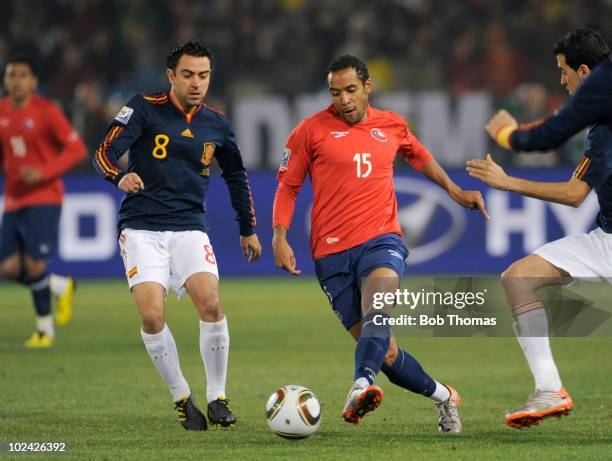 Jean Beausejour of Chile battles for the ball with Xavi of Spain during the 2010 FIFA World Cup South Africa Group H match between Chile and Spain at...