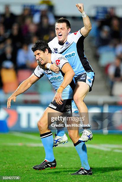 Trent Barrett and Nathan Gardner of the Sharks celebrate after winning the round 16 NRL match between the North Queensland Cowboys and the Cronulla...