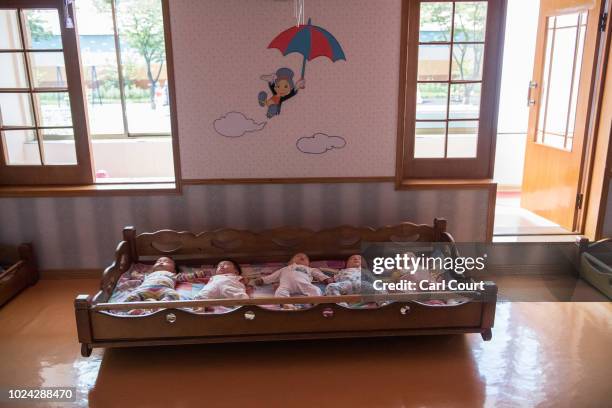 Employee's babies sleep in the nursery at the Kim Jong Suk Silk Factory on August 21, 2018 in Pyongyang, North Korea. Despite ongoing international...