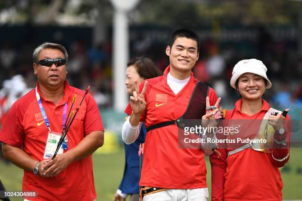 Xinyan Zhang and Tianyu Xu of China celebrate their bronze medals during Recurve Mixed Team Archery Final Rounds on day nine of the Asian Games on...