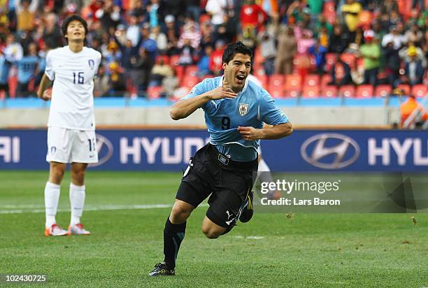 Luis Suarez of Uruguay celebrates scoring the opening goal during the 2010 FIFA World Cup South Africa Round of Sixteen match between Uruguay and...