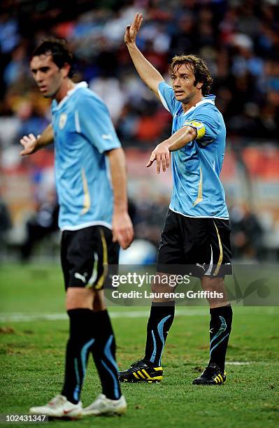 Captain Diego Lugano of Uruguay directs his team mates during the 2010 FIFA World Cup South Africa Round of Sixteen match between Uruguay and South...