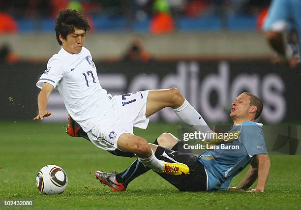 Lee Chung-Yong of South Korea catches Diego Perez of Uruguay in the chest with his boot during the 2010 FIFA World Cup South Africa Round of Sixteen...