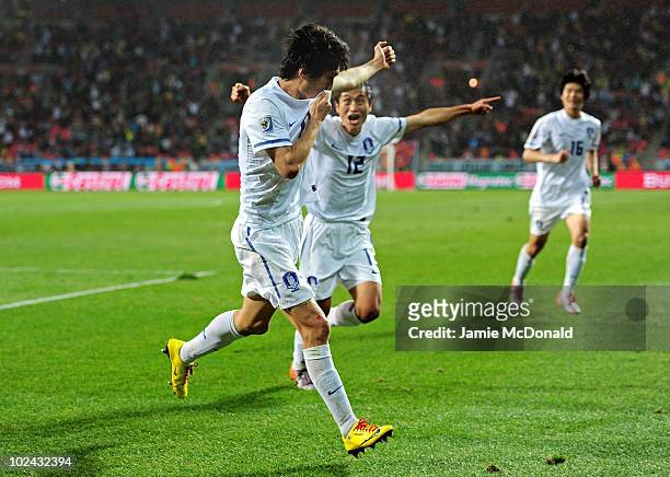 Lee Chung-Yong of South Korea celebrates scoring his team's first goal with Lee Young-Pyo during the 2010 FIFA World Cup South Africa Round of...