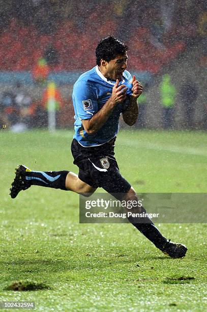 Luis Suarez of Uruguay celebrates scoring his second goal during the 2010 FIFA World Cup South Africa Round of Sixteen match between Uruguay and...