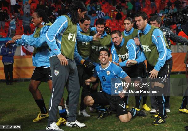 Luis Suarez of Uruguay celebrates scoring his second goal with team mates during the 2010 FIFA World Cup South Africa Round of Sixteen match between...