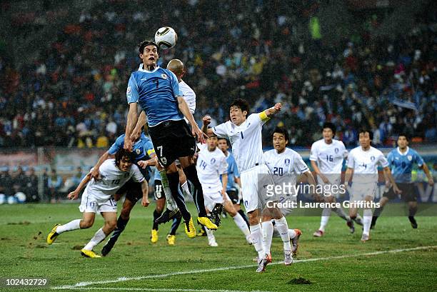 Edinson Cavani of Uruguay goes up for a header as Park Ji-Sung of South Korea attempts to defend during the 2010 FIFA World Cup South Africa Round of...