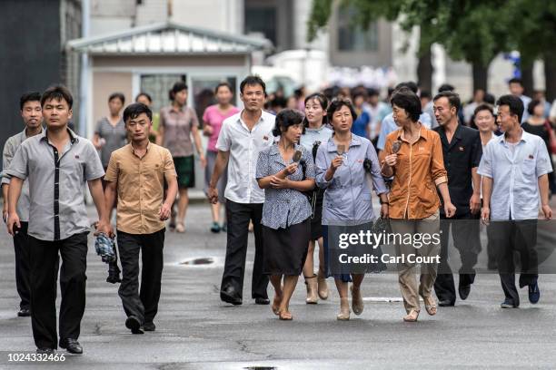 People walk along a street on August 24, 2018 in Pyongyang, North Korea. Despite ongoing international negotiations aimed at easing tensions on the...