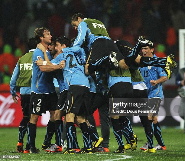 Uruguay players celebrate victory following the 2010 FIFA World Cup South Africa Round of Sixteen match between Uruguay and South Korea at Nelson...