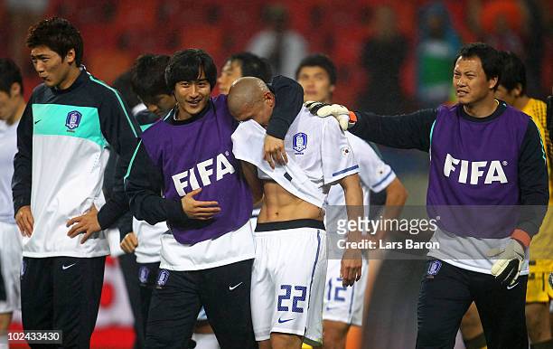Cha Du-Ri of South Korea is consoled by team mate Ahn Jung-Hwan after being knocked out of the competition during the 2010 FIFA World Cup South...