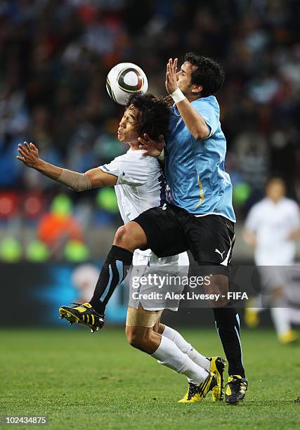 Park Chu-Young of South Korea and Mauricio Victorino of Uruguay battle for the ball during the 2010 FIFA World Cup South Africa Round of Sixteen...