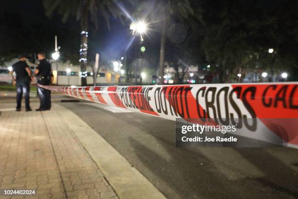 Police tape is seen as law enforcement officials investigate a shooting at the GLHF Game Bar located in the Jacksonville Landing on August 27, 2018...