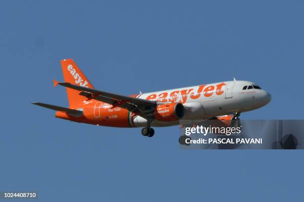 This photo taken on August 27, 2018 shows an Airbus A319 of EasyJet as it flies above Toulouse, southern France.