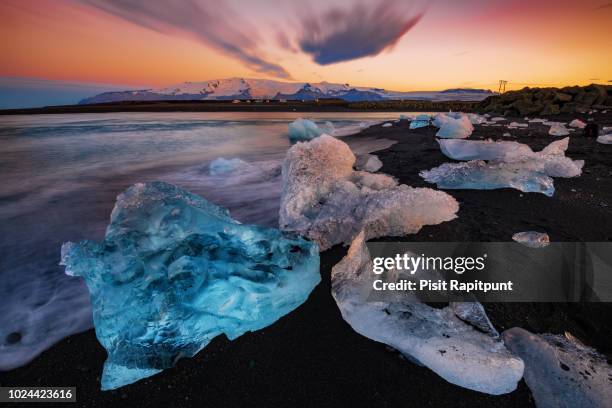 ice rock on the black sand beach at diamond beach - jokulsarlon lagoon ストックフォトと画像