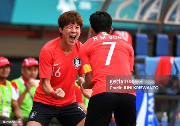 South Korea's Hwang Ui Jo celebrates with a teammate Son Heung Min after scoring a goal against Uzbekistan's during the quarter-final men's football...