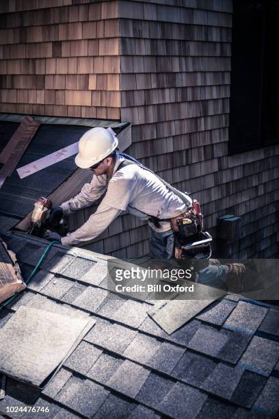 man installing asphalt roof - tarmac worker stock pictures, royalty-free photos & images
