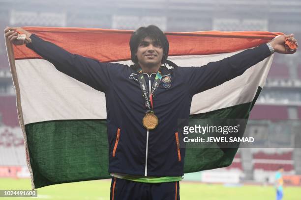 Gold medallist India's Neeraj Chopra celebrates during the victory ceremony for the men's javelin throw athletics event during the 2018 Asian Games...