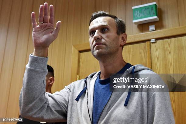 Russian opposition leader Alexei Navalny gestures during his trial at a Moscow courthouse on August 27, 2018. A Moscow court on August 27, 2018 gave...