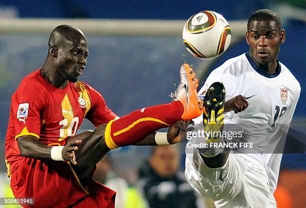 Midfielder Maurice Edu fights for the ball with Ghana's midfielder Stephen Appiah during the 2010 World Cup round of 16 football match between the...