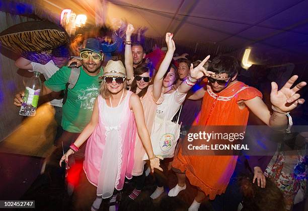 Revellers show off their retro sleepwear on two giant beds within the "Slumber Rave" in the early hours of the final day of the Glastonbury festival...