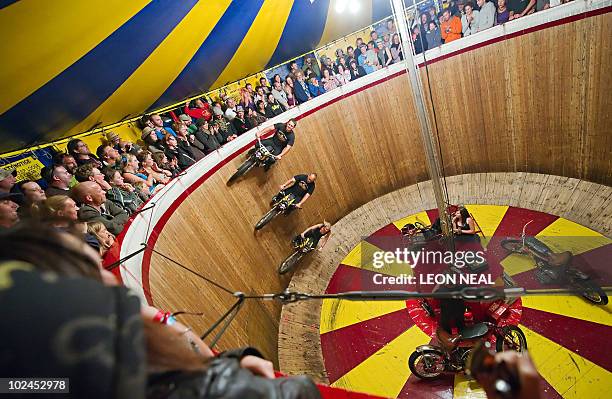 Three riders take the "Wall of Death" in the Block 9 area of the Glastonbury festival near Pilton, Somerset on June 26, 2010. Celebrating its 40th...