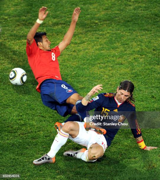 Sergio Ramos of Spain tackles Arturo Vidal of Chile during the 2010 FIFA World Cup South Africa Group H match between Chile and Spain at Loftus...