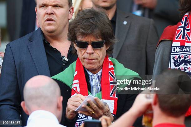 Mick Jagger signs an autograph prior to the 2010 FIFA World Cup South Africa Round of Sixteen match between Germany and England at Free State Stadium...