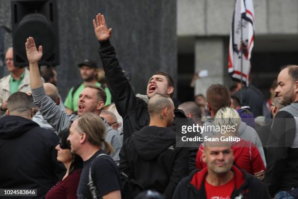 Man raises his arm in a Heil Hitler salute towards heckling leftists at a right-wing protest gathering the day after a man was stabbed and died of...