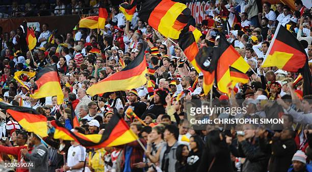Germany's supporters react after midfielder Thomas Mueller scored Germany's 3rd goal during the 2010 World Cup round of 16 football match England...