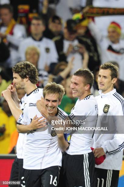 Germany's defender Philipp Lahm and Germany's striker Lukas Podolski celebrate after the 2010 World Cup round of 16 match Germany vs England on June...