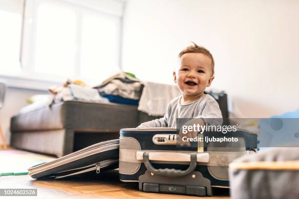 adorable baby boy in suitcase having fun - baby bag stock pictures, royalty-free photos & images