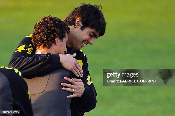 Brazil's midfielder Kaka hugs teammate Elano during a training session at Randburg High School in Johannesburg on June 27, 2010 during the 2010 World...