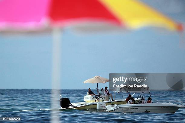 Boat uses absorbent pads to soak what oil residue it can before it washes ashore from the Deepwater Horizon oil spill in the Gulf of Mexico on June...