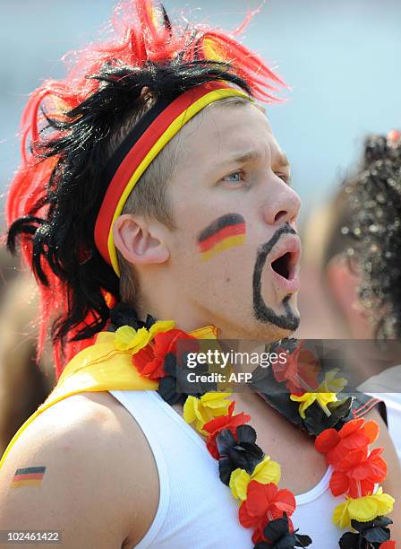 Fan of the German national football team attends the public viewing event of the World Cup match between England and Germany in the southern German...