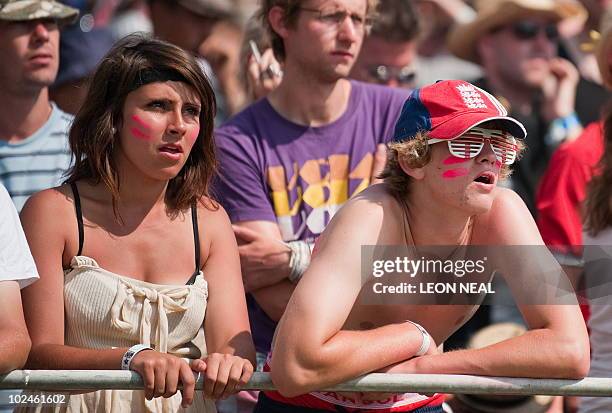 English football fans react as Germany score another goal against England on the final day of the Glastonbury festival near Pilton, Somerset on June...