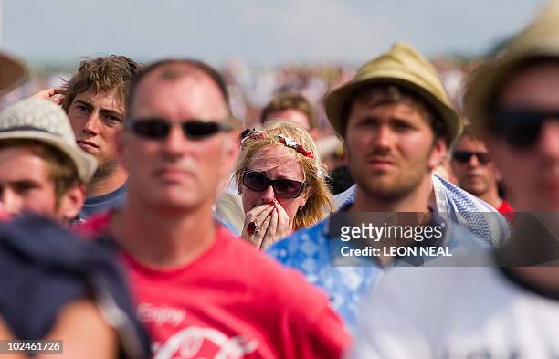 English football fans watch the England vs Germany World Cup match on the final day of the Glastonbury festival near Pilton, Somerset on June 27,...
