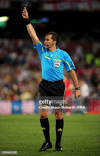 Referee Jorge Larrionda shows a yellow card during the 2010 FIFA World Cup South Africa Round of Sixteen match between Germany and England at Free...