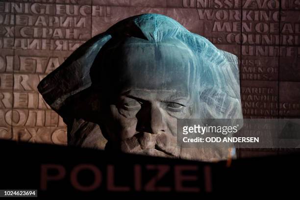 Police Water Cannon is seen in front of a sculpture of Karl Marx where Right-wing demonstrators staged a rally on August 27, 2018 in Chemnitz,...