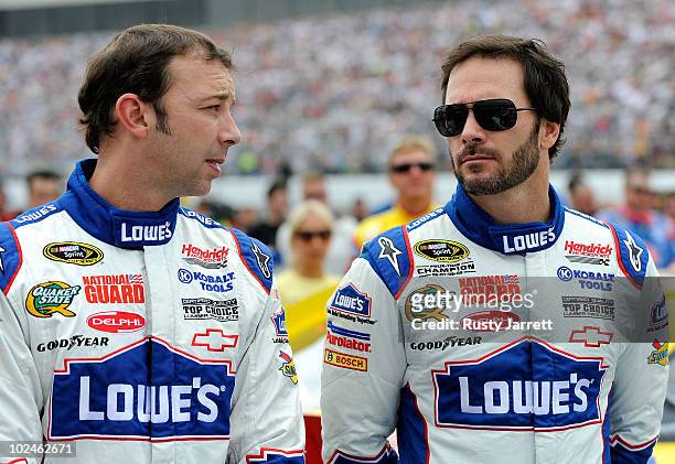 Jimmie Johnson , driver of the Lowe's Chevrolet, talks with crew chief Chad Knaus on the grid prior to the start of the NASCAR Sprint Cup Series...