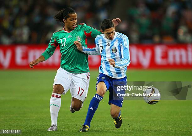 Giovani Dos Santos of Mexico and Angel Di Maria of Argentina battle for the ball during the 2010 FIFA World Cup South Africa Round of Sixteen match...