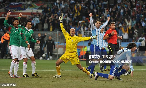 Argentina's striker Lionel Messi celebrates with teammates after scoring as Mexico's goalkeeper Oscar Perez reacts during the 2010 World Cup round of...