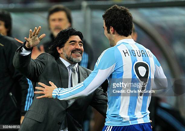 Diego Maradona head coach of Argentina celebrates with Gonzalo Higuain after he scores his side's second goal during the 2010 FIFA World Cup South...
