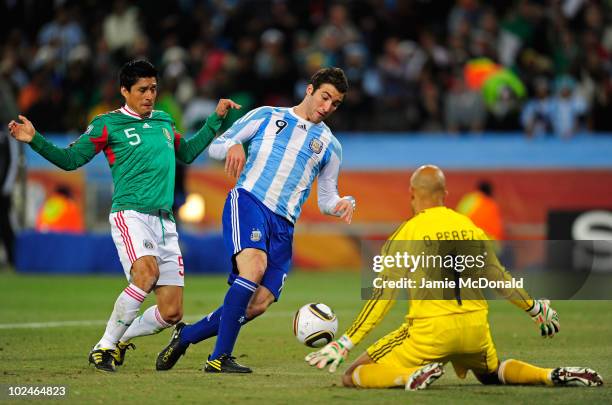 Gonzalo Higuain of Argentina scores his side's second goal past Oscar Perez of Mexico during the 2010 FIFA World Cup South Africa Round of Sixteen...