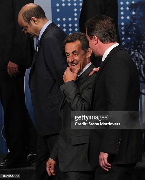 French President Nicolas Sarkozy and Britain's Prime Minister David Cameron along with other attend a group photo during the G20 summit June 27, 2010...