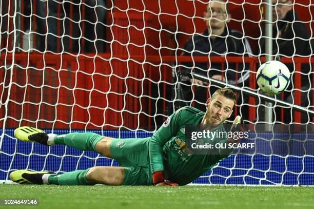 Manchester United's Spanish goalkeeper David de Gea makes a save during the English Premier League football match between Manchester United and...