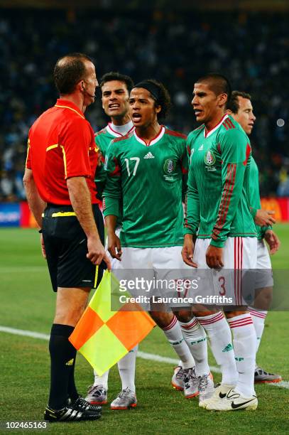 Giovani Dos Santos of Mexico and team mates appeal to referee assistant Stefano Ayroldi over the Carlos Tevez goal during the 2010 FIFA World Cup...